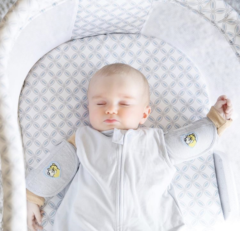 An infant using Swaddle Sleeves. Mom's Choice Awards